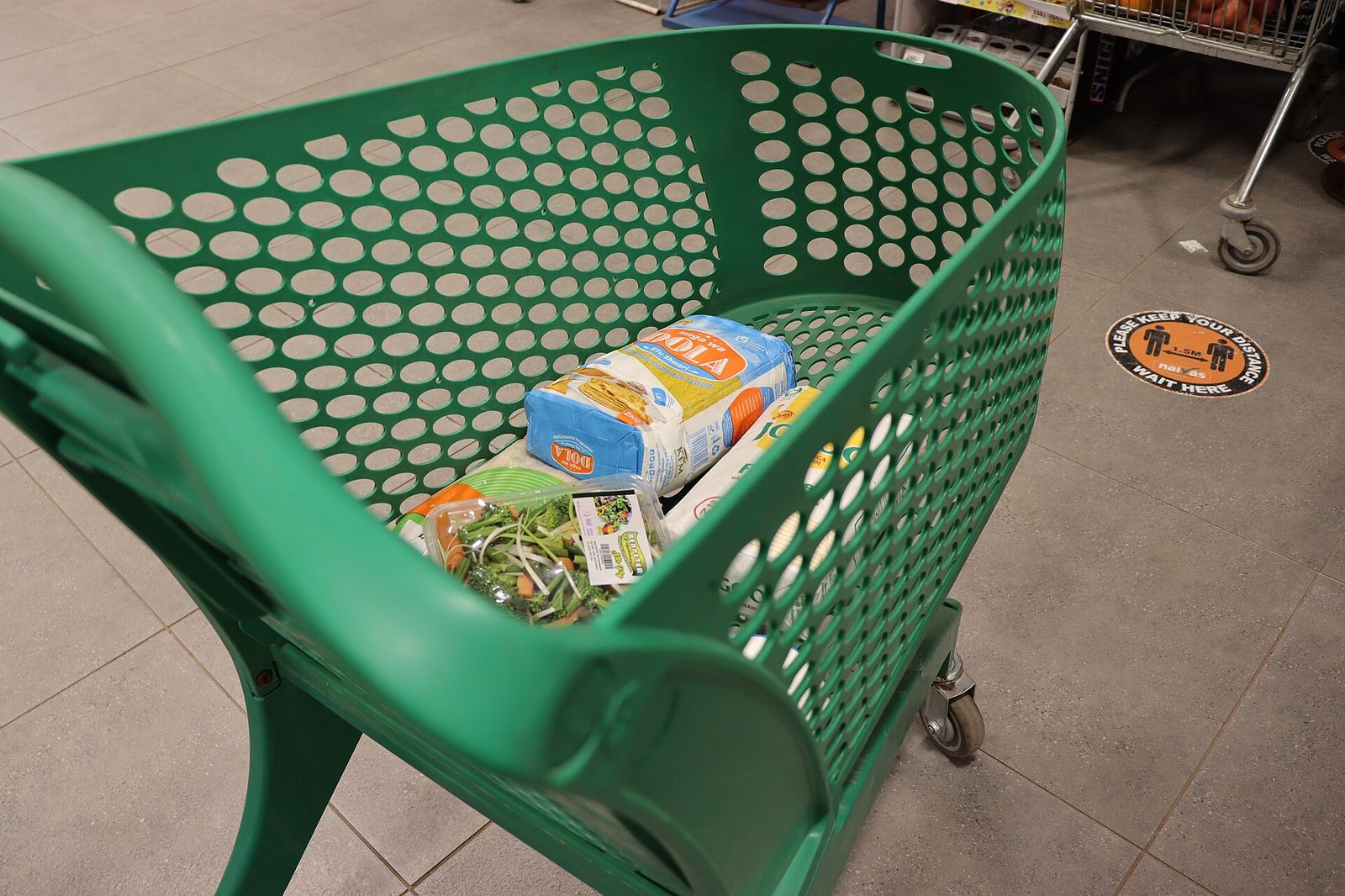 Shopping cart in a supermarket aisle